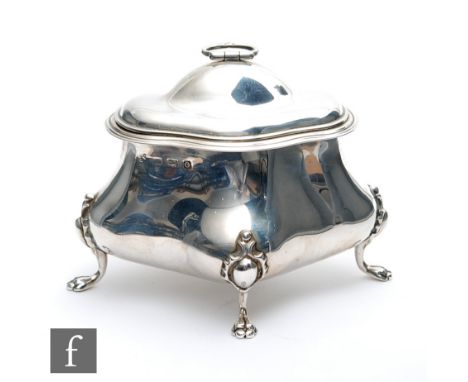 A hallmarked silver tea caddy oval plain shaped oval form raised on four paw feet below hinged cover with ring handle, weight