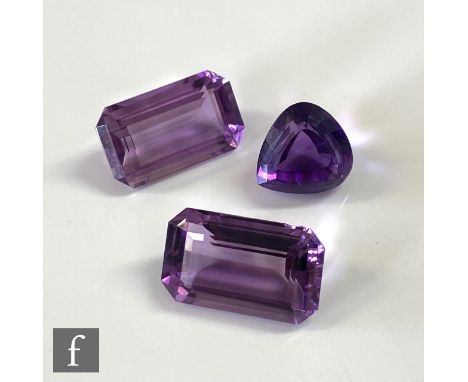 A cut and polished heart shaped amethyst, 3.5mm x 2.7mm x 9.4mm, with two emerald cut amethyst stones, 19.5mm x 12mm x 8mm, w