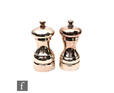 A hallmarked silver pepper and salt mill, each of plain baluster form, pepper with gilt finial, heights 11cm, Birmingham 2008