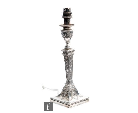 A hallmarked silver candlestick decorated with ram's heads and swag decoration, later converted to electricity, height 32cm, 