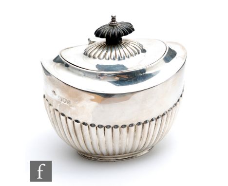 A hallmarked silver boat shaped tea caddy with part fluted decoration below hinged cover, weight 5.5oz, length 12cm, London 1