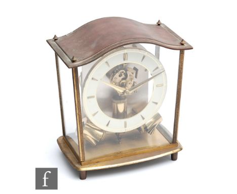 A mid 20th Century Junghans ATO electric mantel clock, with baton numerals to the cream coloured dial, all beneath a lift ove