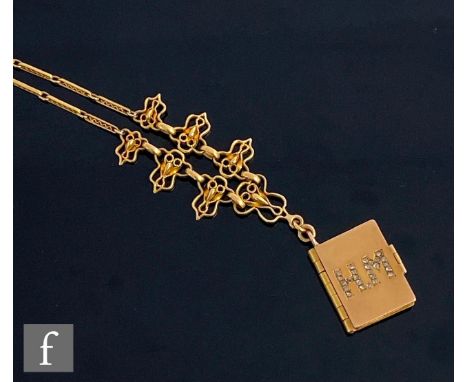 A French 18ct pendant modelled as a three page book with diamond set initials H.M to front, length 20mm, suspended from an 18