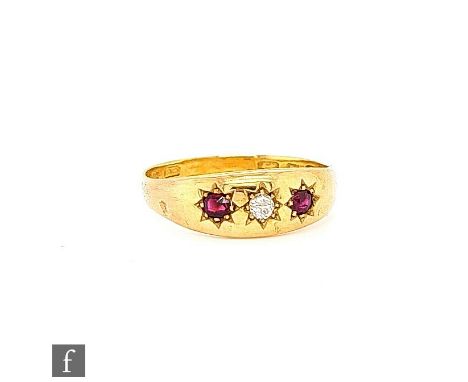 An early 20th Century ruby and diamond three stone ring, gypsy set stones to a 9ct head and later 22ct hallmarked half shank,