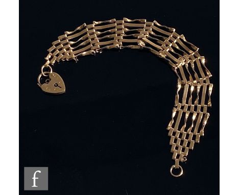 A modern 9ct hallmarked six bar gate bracelet terminating in padlock fastener, weight 11.5g, S/D. 