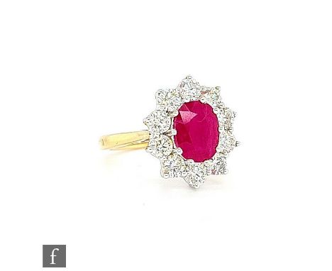 An 18ct ruby and diamond cluster ring, central oval ruby, weight 2.25ct, within a border of ten brilliant cut diamonds, total