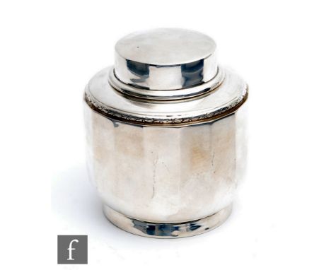 An Art Deco hallmarked silver circular panelled tea caddy of plain form with a plain pull off cover, weight 4.5oz, height 9cm
