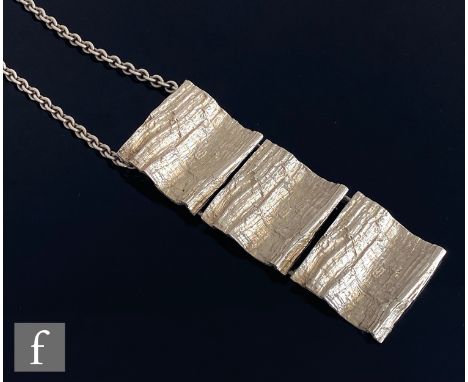 A modernist necklace designed by Anton Michelsen formed as three textured panels suspended from a cable link chain, import ma