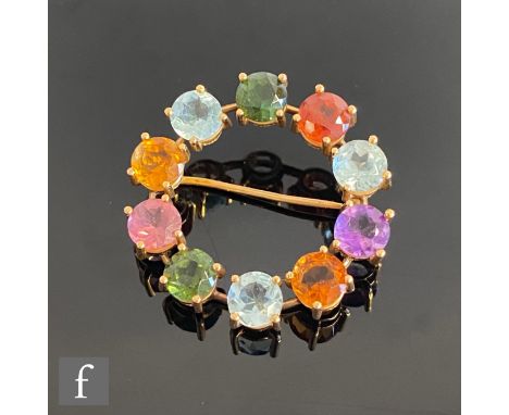 A mid 20th Century multi stone circular brooch set with blue zircon, green tourmaline, amethyst and citrene, all to an unmark