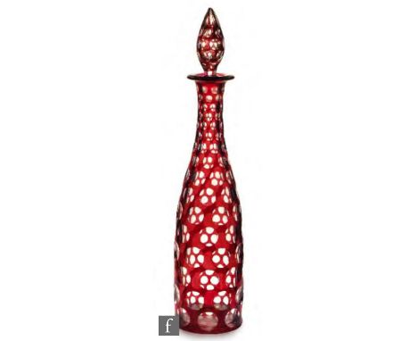 A 19th Century Bohemian glass decanter, circa 1860, the clear cylindrical body cased in ruby and flash cut with roundels, wit