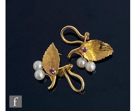 A pair of 18ct hallmarked stud earrings each modelled as a leaf detailed with two cultured pearls and a single ruby, total we