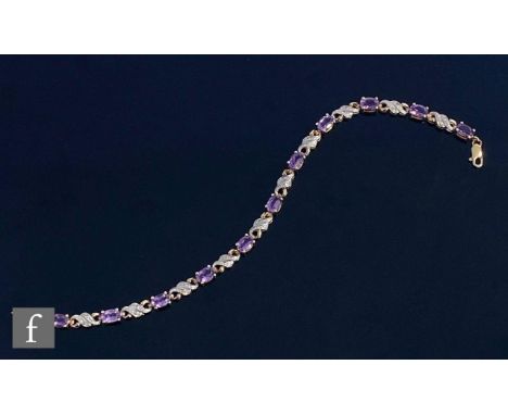 A 9ct hallmarked amethyst and diamond bracelet comprising eleven oval claw set amethysts spaced by pairs of diamonds to a scr