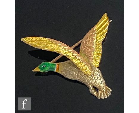 A 9ct hallmarked three coloured gold brooch modelled as a mallard in flight with enamel detail to head, weight 8g, length 4cm