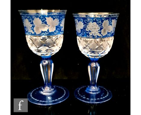 A near pair of early 20th Century continental wine glasses, the ogee bowl decorated with a band of diamond cuts below a band 