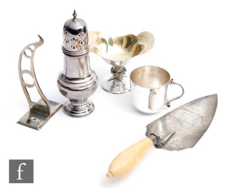 Five assorted hallmarked silver items to include a trowel, a small pedestal bowl, a sugar castor, a small mug and a wall brac