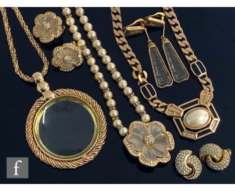 A small parcel lot of assorted costume jewellery to include Dior earrings and faux pearl pendant, two further pendants and ch