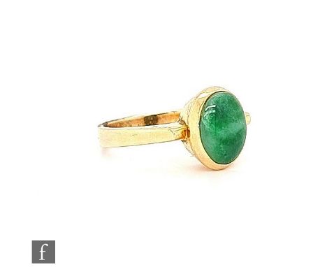 A 14ct single stone jade ring, oval collar set stone to angular shoulders, weight 4.5g, ring size K. 