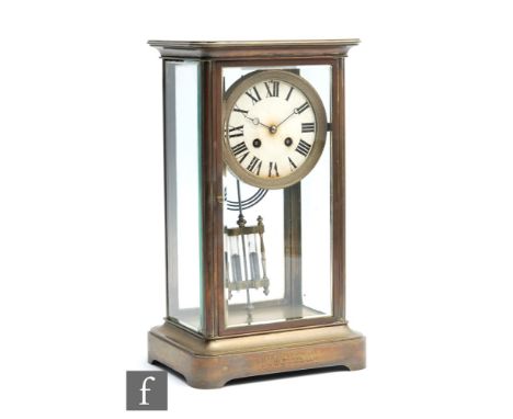 An early 20th Century French regulator mantel clock, the brass case with bevel cut glass panels enclosing the eight day movem