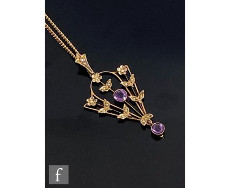 An early 20th Century 9ct amethyst and seed pearl open work pendant terminating in amethyst drop, length 5cm, suspended from 