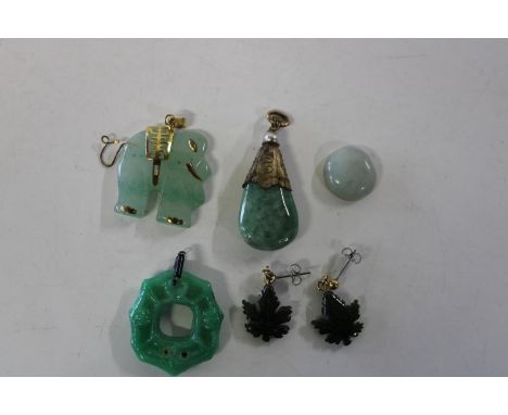 A selection of Chinese jade pendants with yellow metal fittings 