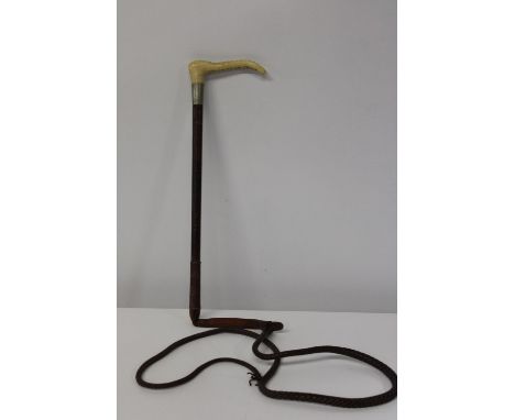 A vintage Moss Bros riding crop 