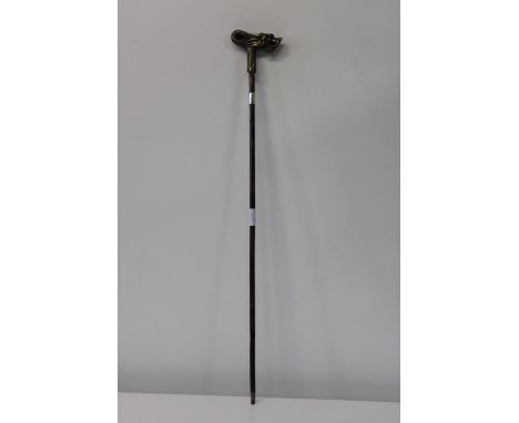 A silver collared walking stick with a dragon form handle 