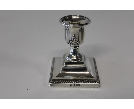 A hallmarked silver squat candle stick 9cm h 