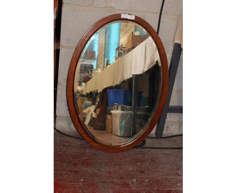 A large oval framed bevelled edged vintage mirror. 81cm x 57cm collection only 