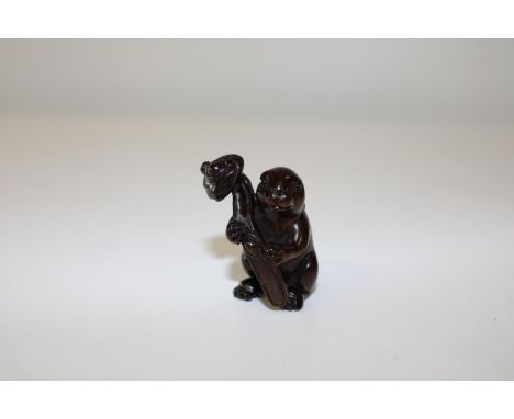 A boxwood netsuke in the form of a rat 