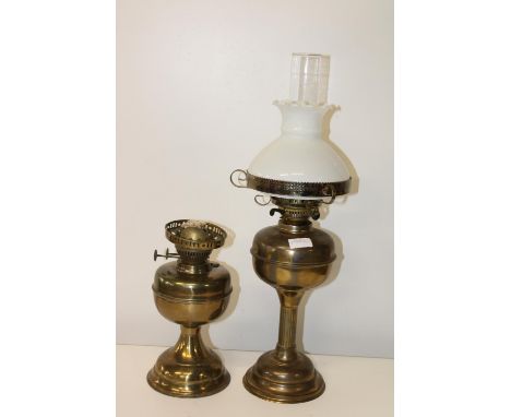 Two vintage brass oil lamp bases one with shade 