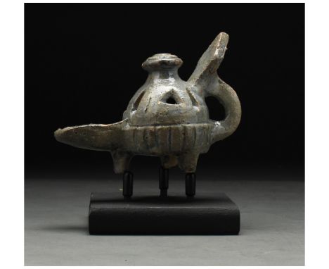 ca. 1100 AD. Seljuk. This intriguing medieval Islamic period glazed lamp was probably made under the Seljuk dynasty. The lamp