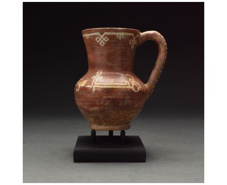 Ca. 1000 AD. Beautiful Medieval Persian terracotta jug in a mid reddish-brown fabric with cream painted geometric decoration.
