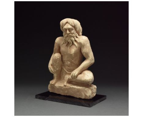 100 – 300 AD. Gandharan. A grey schist figure of Atlas in a crouching position, with his hands braced against his knees, rest