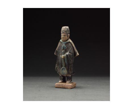 Ca. 1368-1644 AD. Chinese Ming Dynasty Attendant Figure. An elaborately crafted male attendant figure dressed in a deep blue 