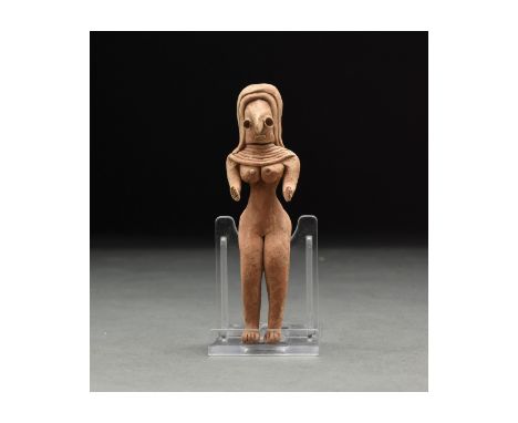 C. 3rd millennium BC. A lovely ochre-coloured handmade fertility idol of characteristically abstract form with delineated leg