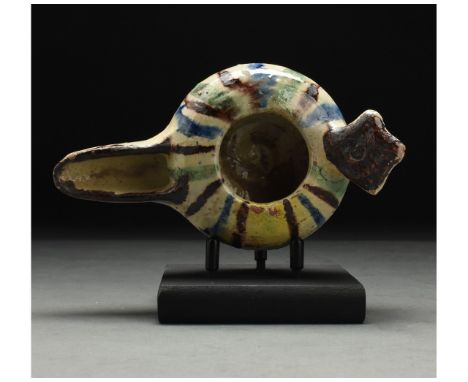 ca. 1100 AD. Seljuk. This intriguing medieval Islamic period glazed lamp was probably made under the Seljuk dynasty. The lamp