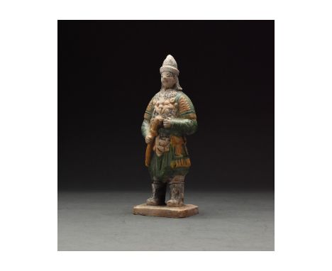 Ca. 1368-1644 AD. Chinese Ming Dynasty Attendant Figure. An elaborately crafted warrior attendant figure dressed and orange a