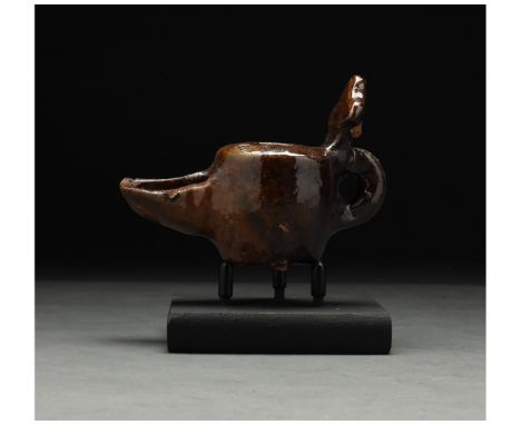 ca. 1100 AD. Seljuk. This intriguing medieval Islamic period glazed lamp was probably made under the Seljuk dynasty. The lamp