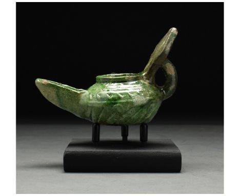 ca. 1100 AD. Seljuk. This intriguing medieval Islamic period glazed lamp was probably made under the Seljuk dynasty. The lamp