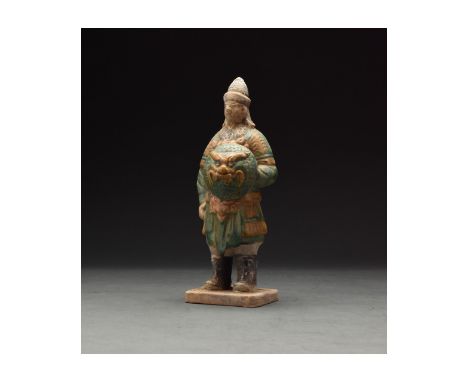 Ca. 1368-1644 AD. Chinese Ming Dynasty Attendant Figure. An elaborately crafted warrior attendant figure dressed and orange a