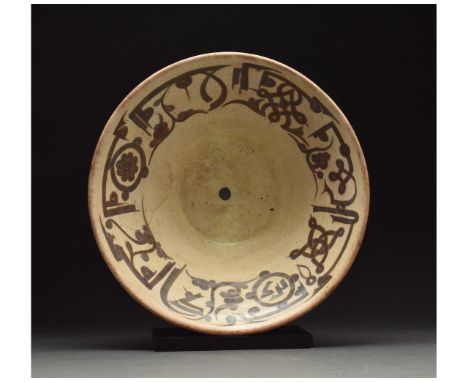 900 - 1000 AD or later. Medieval Islamic terracotta plate or bowl in a light brown fabric with a cream glazed interior. Brown