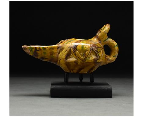 ca. 1100 AD. Seljuk. This intriguing medieval Islamic period glazed lamp was probably made under the Seljuk dynasty. The lamp