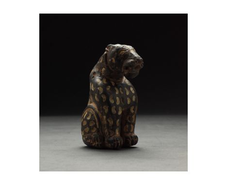 2000-1000 millennium BC or later. Western Asiatic. Dark brown carved stone figure of a tiger or other large feline. The tiger