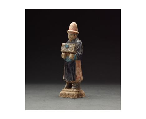 Ca. 1368-1644 AD. Chinese Ming Dynasty Attendant Figure. An elaborately crafted male attendant figure dressed in a dark blue 