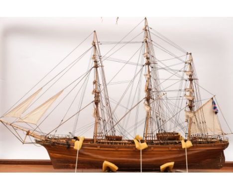 A scale model of the Cutty Sark:, fully rigged with furled mainsails over deck with cabins and fixtures and fittings, on a va