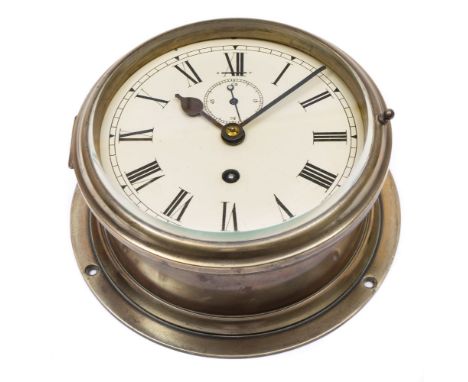 A brass cased circular bulkhead clock:, unsigned, white enamel dial with Roman numerals and subsidiary seconds dial, 21cm dia