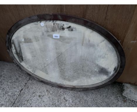 AN OVAL OAK WALL MIRROR 