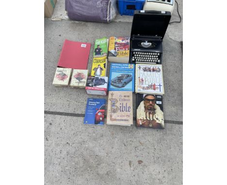A SILVER-REED TYPEWRITER AND AN ASSORTMENT OF BOOKS 