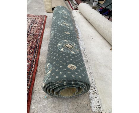 A PART ROLL OF GREEN PATTERNED CARPET 