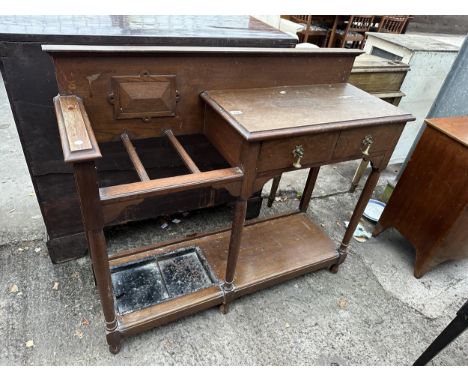 AN EARLY 20TH CENTURY OAK THREE DIVISION STICK STAND TABLE ENCLOSING TWO DRAWERS WITH RAISED RACK, 45" WIDE 